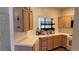 Bright kitchen boasts wooden cabinets, tiled countertops, and an efficient layout for cooking and cleaning at 1947 Cutlass Dr # 0, Henderson, NV 89014
