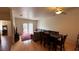 Cozy living room with an adjacent dining area, hardwood floors, and sliding glass doors at 1947 Cutlass Dr # 0, Henderson, NV 89014