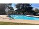 Sparkling community pool surrounded by lush greenery, perfect for summer relaxation and recreation at 1947 Cutlass Dr # 0, Henderson, NV 89014