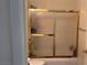The shower has ornate, frosted, sliding glass doors and gold trim at 1947 Cutlass Dr # 0, Henderson, NV 89014