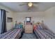 Bright bedroom showcasing two twin beds, a dresser, and a ceiling fan at 2008 Mesquite Ln # 305, Laughlin, NV 89029