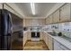 Kitchen with white countertops, wood-look floors and black refrigerator at 2008 Mesquite Ln # 305, Laughlin, NV 89029