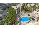 Aerial view of a community pool and jacuzzi surrounded by tall palm trees and lush landscaping at 2008 Mesquite Ln # 305, Laughlin, NV 89029