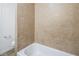 Close up view of a tiled shower with a white tub in a bathroom at 204 Orland St # 2, Las Vegas, NV 89107