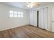 Bright bedroom features wood floors, white walls and trim, shuttered windows, closet, and updated lighting at 204 Orland St # 2, Las Vegas, NV 89107