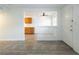 Open-concept living room with decorative half wall, tile flooring, and kitchen view at 204 Orland St # 2, Las Vegas, NV 89107