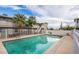A community pool with lounge chairs is surrounded by palm trees and apartments at 204 Orland St # 2, Las Vegas, NV 89107