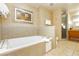 Luxurious bathroom with a soaking tub, neutral tile, and a separate glass shower at 211 E Flamingo Rd # 714, Las Vegas, NV 89169