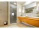 Contemporary bathroom with a glass-enclosed shower and a light wooden vanity at 211 E Flamingo Rd # 714, Las Vegas, NV 89169