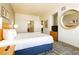 Well-lit bedroom with a plush king bed, decorative mirror, and access to a clean bathroom at 211 E Flamingo Rd # 714, Las Vegas, NV 89169
