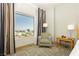 Cozy bedroom corner with a window offering a view of the city skyline at 211 E Flamingo Rd # 714, Las Vegas, NV 89169