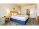 Comfortable bedroom featuring a king-size bed, stylish headboard, and a view into the bathroom at 211 E Flamingo Rd # 714, Las Vegas, NV 89169