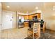 A spacious kitchen with stainless steel appliances, wooden cabinets, and a breakfast bar at 211 E Flamingo Rd # 714, Las Vegas, NV 89169