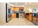 Modern kitchen with stainless steel appliances, wooden cabinets, and black countertops at 211 E Flamingo Rd # 714, Las Vegas, NV 89169