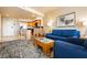 Cozy living room with an open floor plan, adjoined to a modern kitchen and blue sofas at 211 E Flamingo Rd # 714, Las Vegas, NV 89169