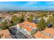 An aerial view captures a community of well-maintained townhomes with desert landscaping and city views at 2292 Cassatt Dr, Henderson, NV 89074