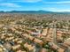This aerial view captures a beautiful, vibrant community nestled against a backdrop of stunning mountain scenery at 2292 Cassatt Dr, Henderson, NV 89074