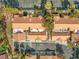 Aerial view of townhomes showcases well maintained landscaping, red tile roofs, and parking areas at 2292 Cassatt Dr, Henderson, NV 89074