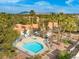 Aerial view of a community pool, surrounded by palm trees and well maintained desert landscaping at 2292 Cassatt Dr, Henderson, NV 89074