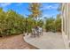 Backyard patio area, perfect for outdoor entertaining, features mature landscaping and a dining set at 2292 Cassatt Dr, Henderson, NV 89074