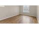 A simple bedroom featuring hardwood floors, neutral walls, and a window view at 2292 Cassatt Dr, Henderson, NV 89074