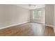 A simple bedroom featuring hardwood floors, neutral walls, and natural light at 2292 Cassatt Dr, Henderson, NV 89074