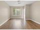 A simple bedroom featuring hardwood floors, neutral walls, and natural light at 2292 Cassatt Dr, Henderson, NV 89074