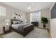 Bedroom with a gray color scheme, ceiling fan, wood-look floors, and a mounted television at 2292 Cassatt Dr, Henderson, NV 89074