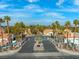 Gated community entrance with palm trees and lush landscaping, offering privacy and security at 2292 Cassatt Dr, Henderson, NV 89074