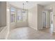 Open dining room with a modern chandelier, neutral walls, decorative wainscoting, and expansive windows at 2292 Cassatt Dr, Henderson, NV 89074