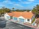 Charming townhome showcases blue garage doors, a red tile roof, and desert landscaping at 2292 Cassatt Dr, Henderson, NV 89074