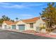 Charming townhome showcases blue garage doors, a red tile roof, and desert landscaping at 2292 Cassatt Dr, Henderson, NV 89074