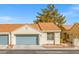 Exterior of a charming home featuring a two-car garage, desert landscaping, and a tile roof at 2292 Cassatt Dr, Henderson, NV 89074