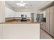 Well-lit kitchen featuring white cabinets, granite countertops, modern appliances and center island, perfect for cooking at 2292 Cassatt Dr, Henderson, NV 89074