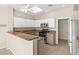 Bright kitchen features granite counters, white cabinets, stainless steel appliances, and an eat-in breakfast bar at 2292 Cassatt Dr, Henderson, NV 89074