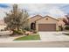 Inviting single-story home with a two-car garage, lush landscaping, and a welcoming entrance at 2388 Aztec Ruin Way, Henderson, NV 89044