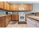 Kitchen with wood cabinets and white appliances at 2388 Aztec Ruin Way, Henderson, NV 89044