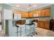 Kitchen featuring wooden cabinets, light countertops, and bar stool seating at 2388 Aztec Ruin Way, Henderson, NV 89044