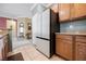 Kitchen featuring stainless steel appliances, wooden cabinets, and adjacent living space at 2388 Aztec Ruin Way, Henderson, NV 89044