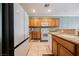 Bright kitchen with modern appliances, wooden cabinets, and tile flooring at 2388 Aztec Ruin Way, Henderson, NV 89044