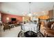 An open-concept living room with a dining area and carpet flooring at 2388 Aztec Ruin Way, Henderson, NV 89044