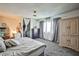 Bright primary bedroom with a walk-in closet, carpeted floor, and neutral-colored furniture at 2540 Eagle St, Las Vegas, NV 89142