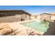 Backyard pool surrounded by a concrete patio adjacent to home and detached shed at 2540 Eagle St, Las Vegas, NV 89142