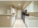 Functional kitchen featuring white cabinets and black appliances at 2615 W Gary Ave # 2051, Las Vegas, NV 89123