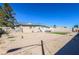 Spacious backyard featuring gravel, a small patch of turf, and a view of neighboring houses at 2990 La Canada St, Las Vegas, NV 89169