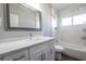 Elegant bathroom featuring white marble-look shower tile, granite countertop, and stylish vanity at 2990 La Canada St, Las Vegas, NV 89169