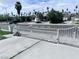 Gated front yard with mature landscaping and concrete driveway at 2990 La Canada St, Las Vegas, NV 89169