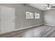 Bright living room with vaulted ceiling, gray walls, wood-look floors, and three windows at 2990 La Canada St, Las Vegas, NV 89169
