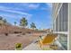 Spacious backyard with rock landscaping, mature trees, and enclosed patio at 3009 Anna Bay Dr, Las Vegas, NV 89134