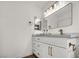 Bright bathroom with sleek white cabinets, marble countertop, and stylish gold fixtures at 3009 Anna Bay Dr, Las Vegas, NV 89134